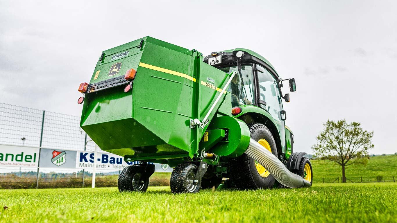 John Deere Compact tractor with material collection system